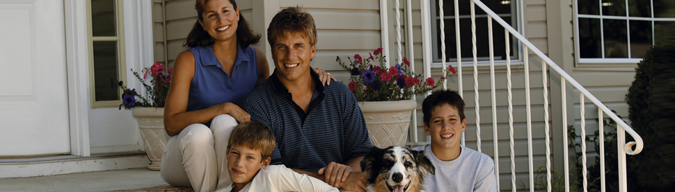 Photo of family outside of house
